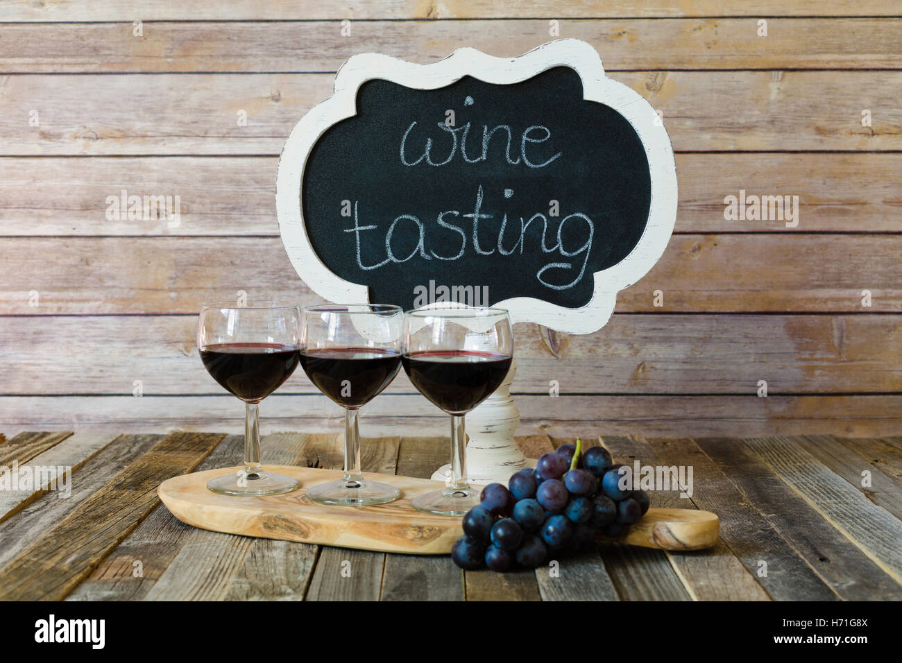 Red wine flight with chalkboard sign and grapes Stock Photo Alamy