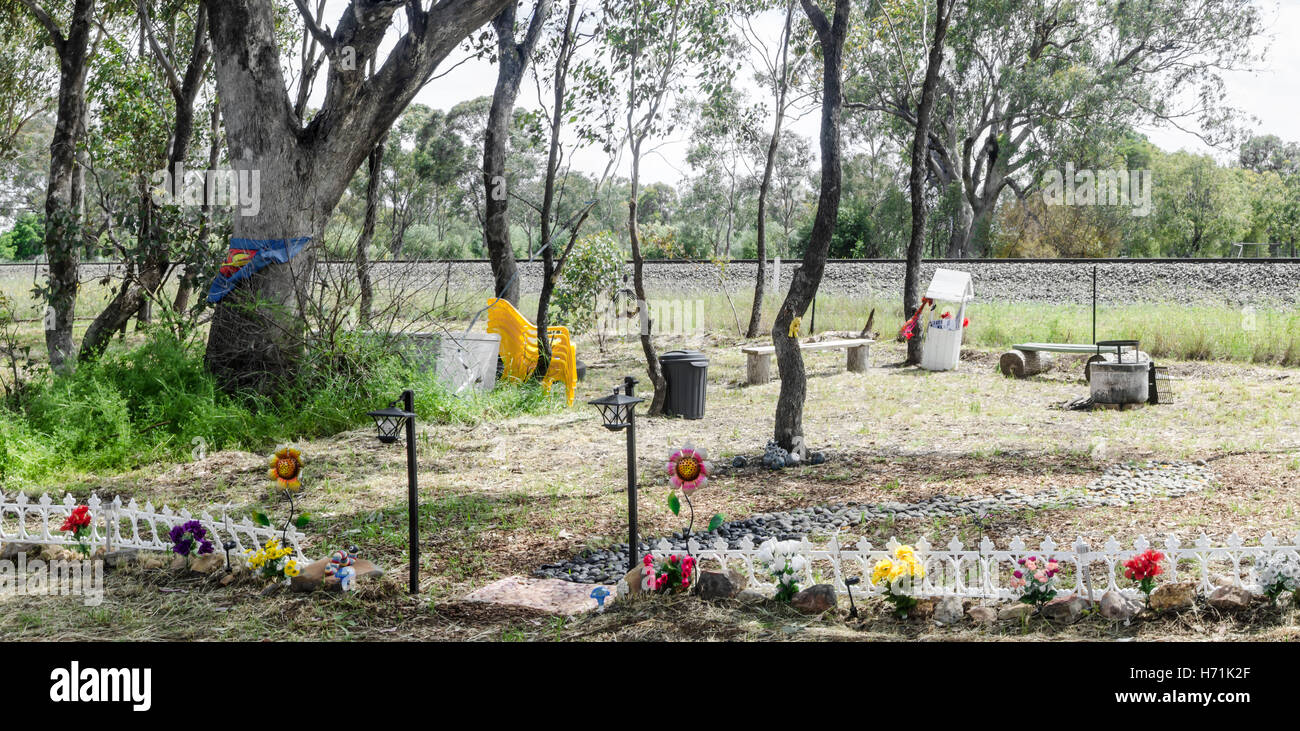 An Elaborate Roadside Memorial Carved out of the bush where two people were killed in a traffic crash. Stock Photo