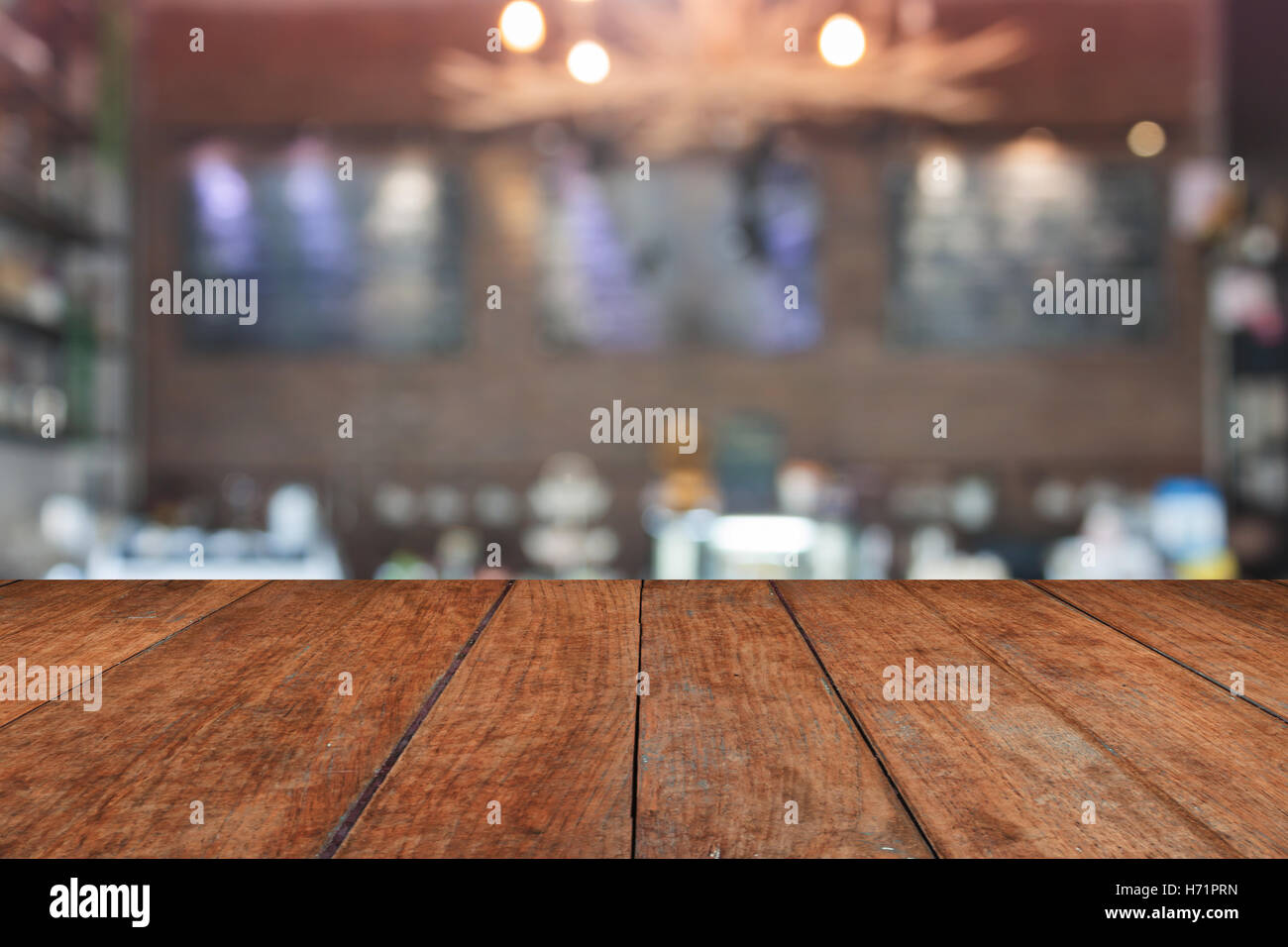 Brown table top with blurred coffee shop interior for background Stock