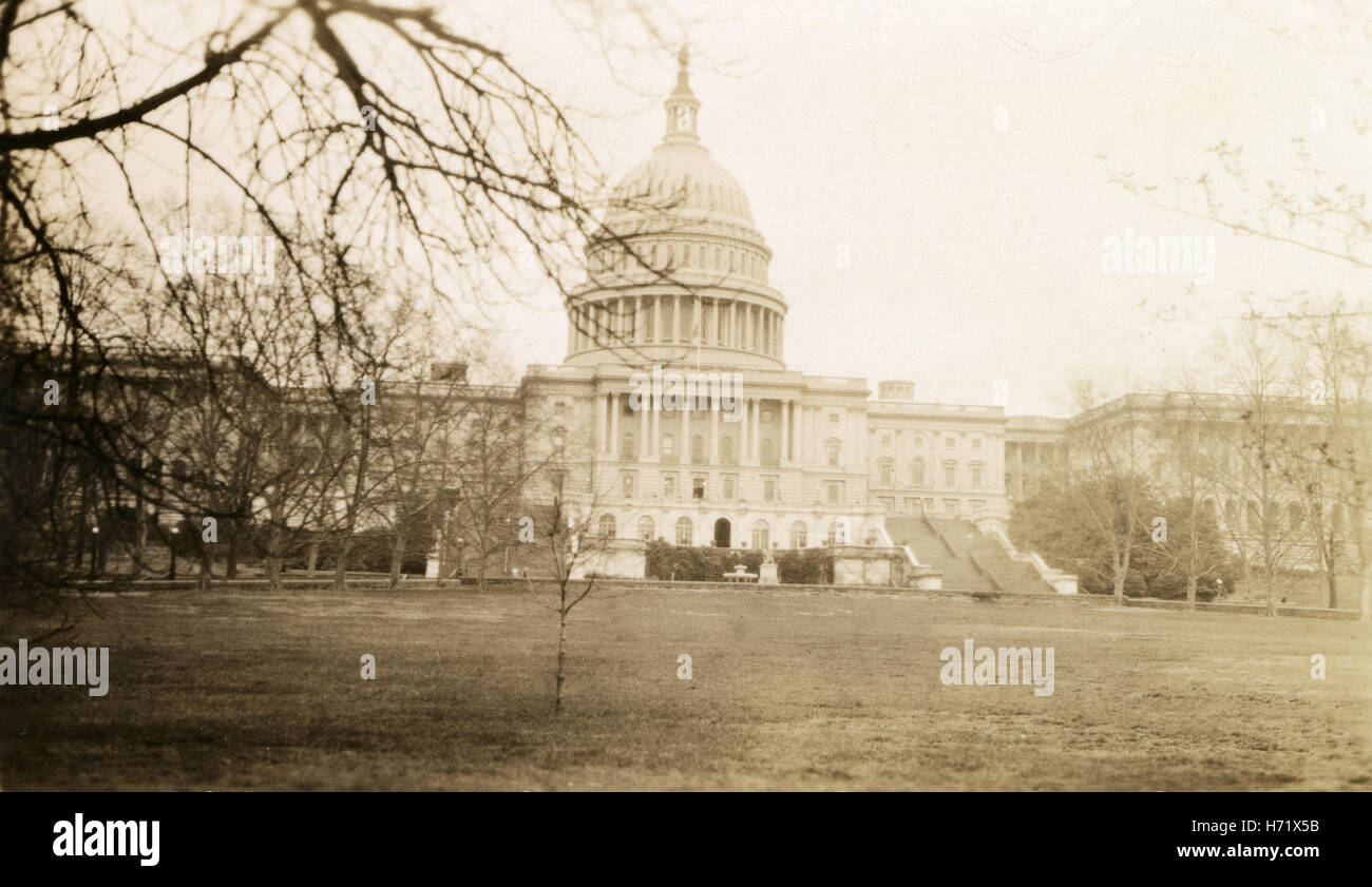 Antique c1920 photograph, the US Capitol Building in Washington, DC. The United States Capitol, often called the Capitol Building or Capitol Hill, is the seat of the United States Congress. It sits atop Capitol Hill, at the eastern end of the National Mall in Washington, D.C. SOURCE: ORIGINAL PHOTOGRAPHIC PRINT. Stock Photo