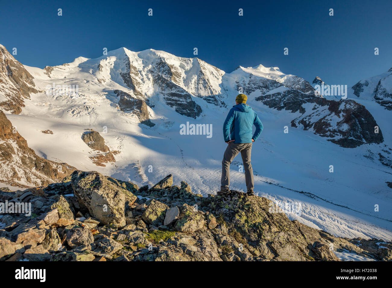 Hiker looking to Piz Palu from Diavolezza. Berniner Alps, Graubunden, Switzerland. Stock Photo