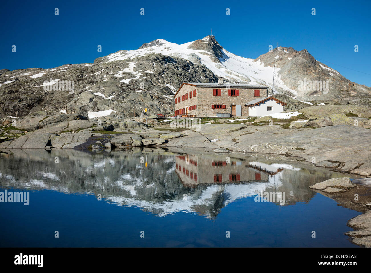 Reflection of Fuorcla Surlej refuge, Silvaplana, above St Moritz. Berniner Alps, Graubunden, Switzerland. Stock Photo