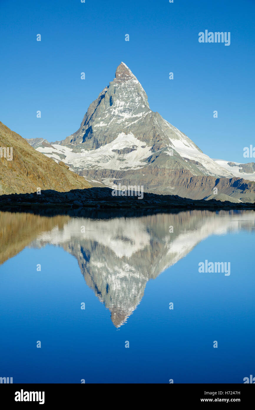 The Matterhorn reflected in the Riffelsee, Zermatt, Pennine Alps, Valais, Switzerland. Stock Photo