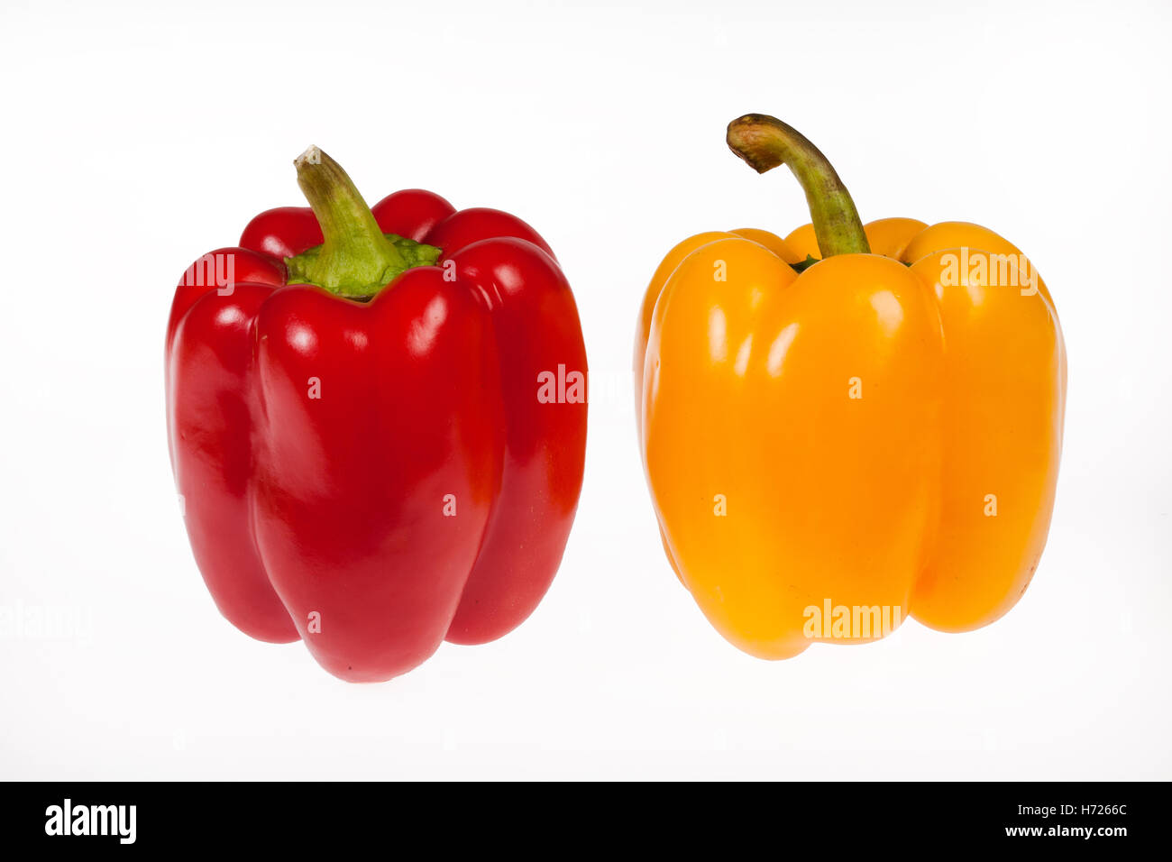 Red and yellow peppers on an isolated studio background Stock Photo - Alamy