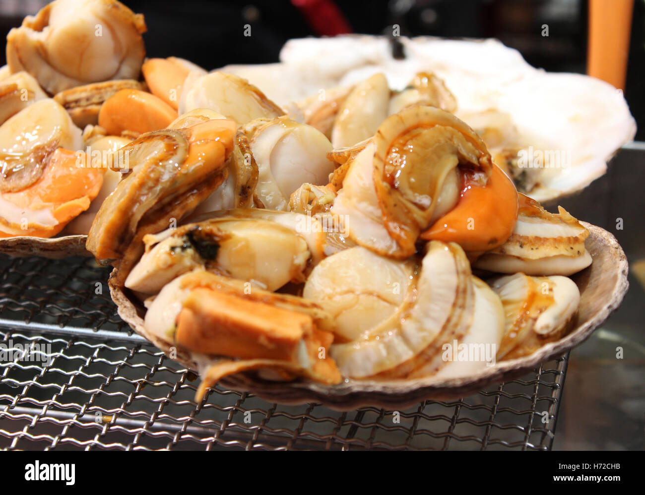 Scallop with the seashell on the grill in Kuromon Ichiba Market, Osaka
