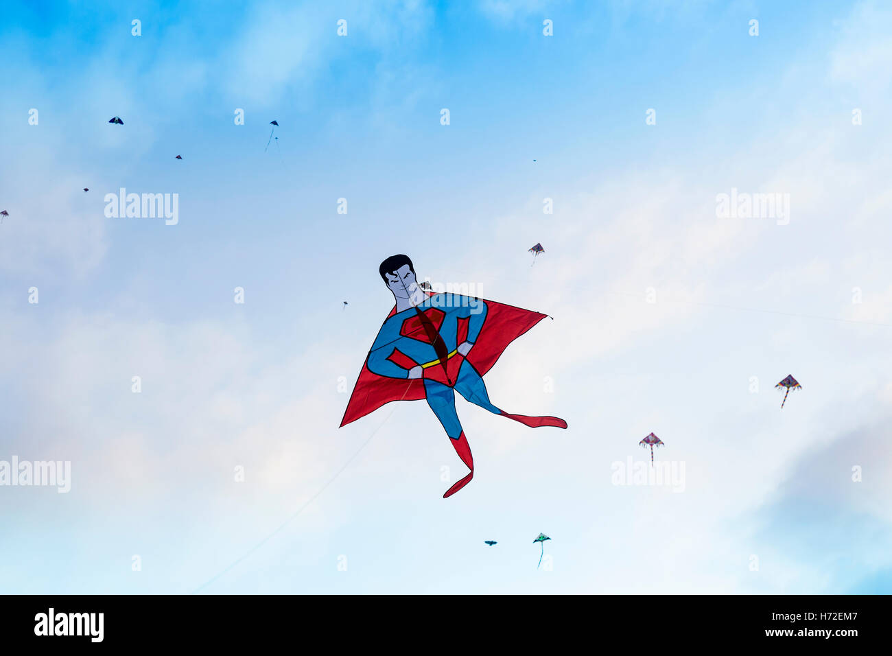 Guangzhou, China. October 2016. Superman Kite flying over a city park with other colorful kites Stock Photo
