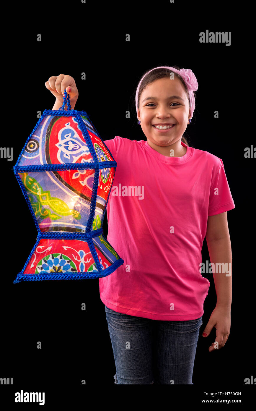Happy Girl with Big Ramadan Lantern on Black Background Stock Photo