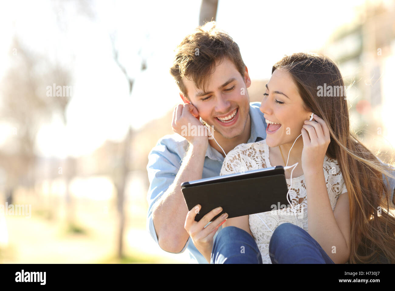 Couple sharing music and singing with a tablet Stock Photo