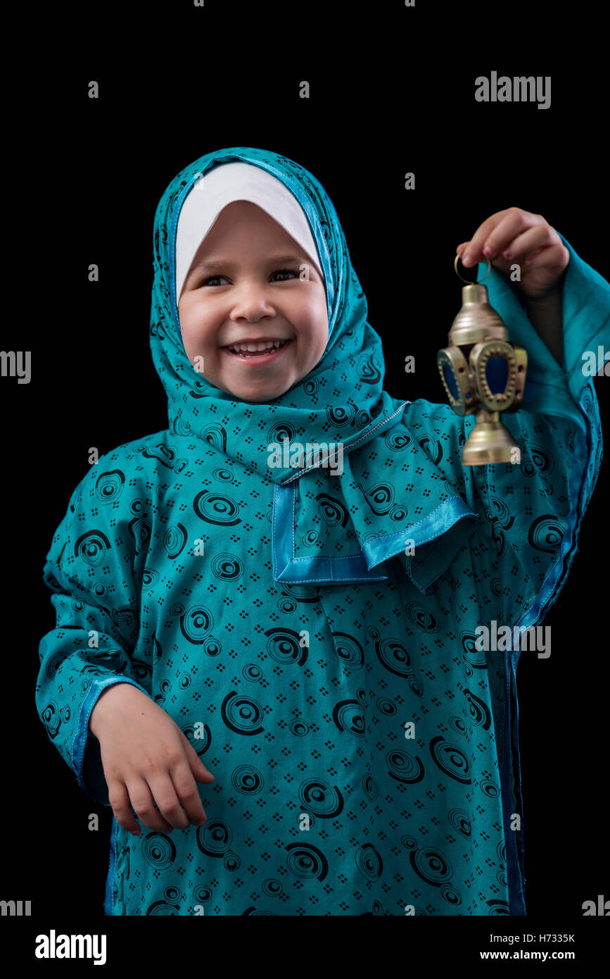 Little Happy Muslim Girl Smiling with Ramadan Lantern Over Black Background Stock Photo