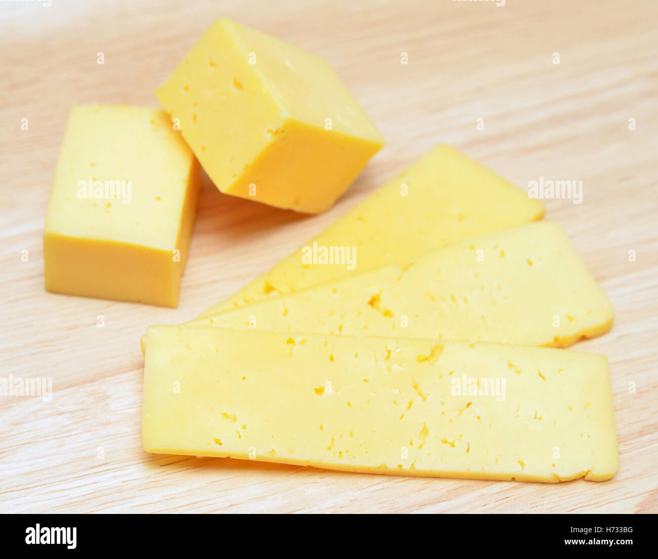 cheese slices on wooden background Stock Photo
