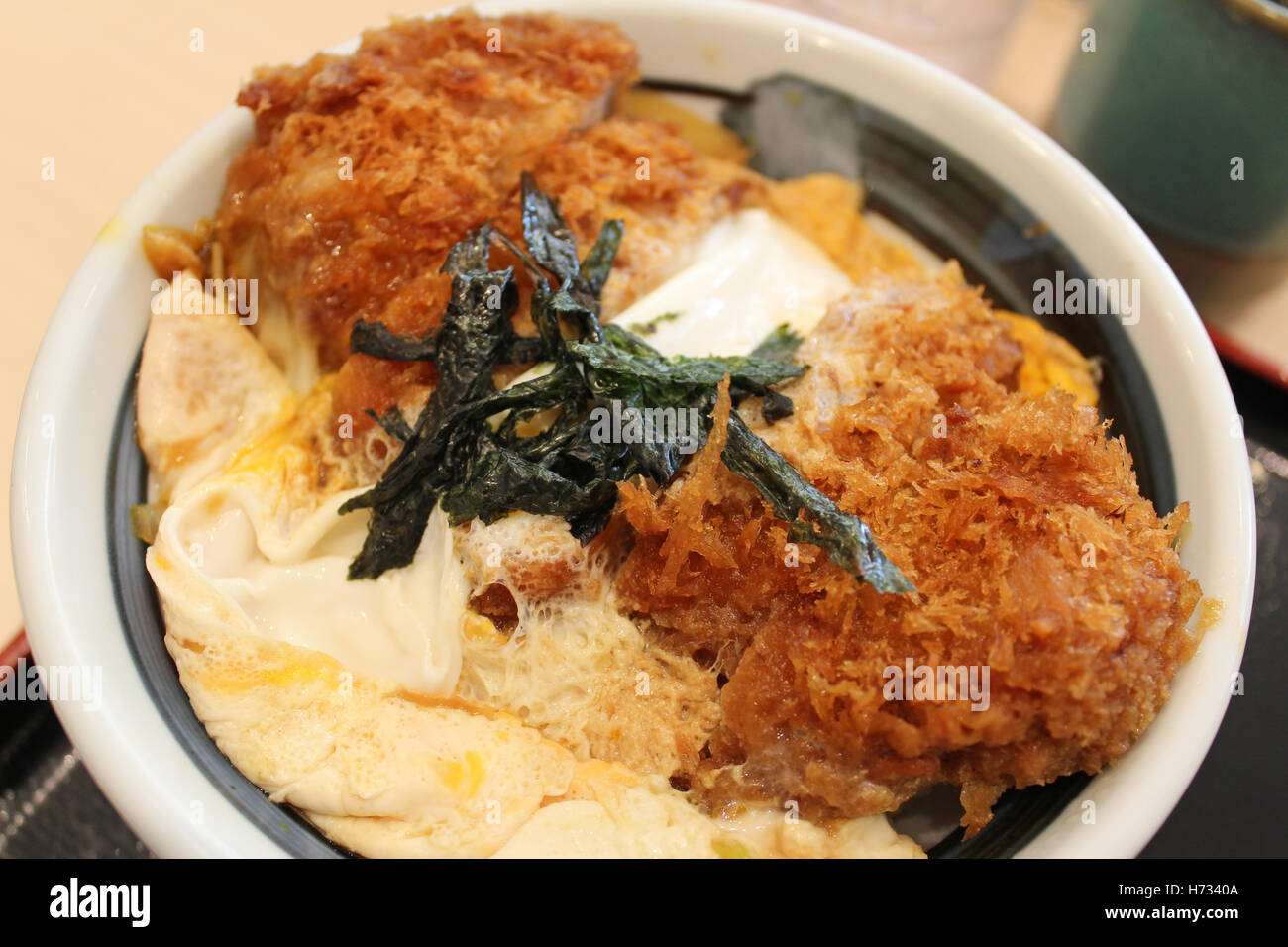 Katsudon is a bowl of rice topped with a deepfried pork cutlet, egg
