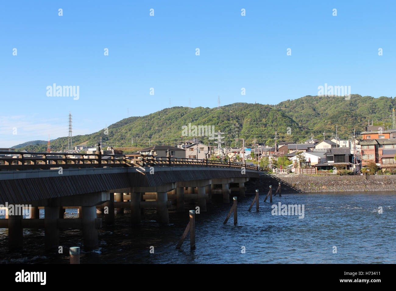 View of Uji city with the Uji Bridge, Uji River, houses, mountain and blue sky, Japan Stock Photo