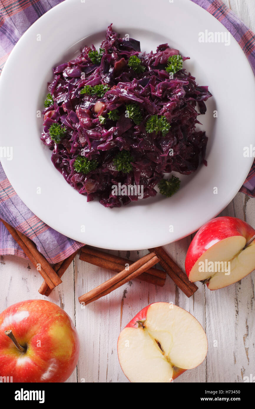 braised red cabbage with apples close up on a plate. vertical view from above Stock Photo