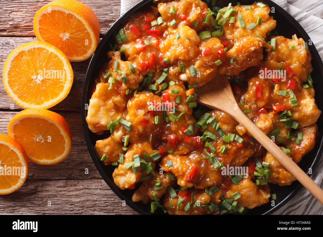 Delicious orange chicken fillets close-up on a plate on the table. horizontal view from above Stock Photo