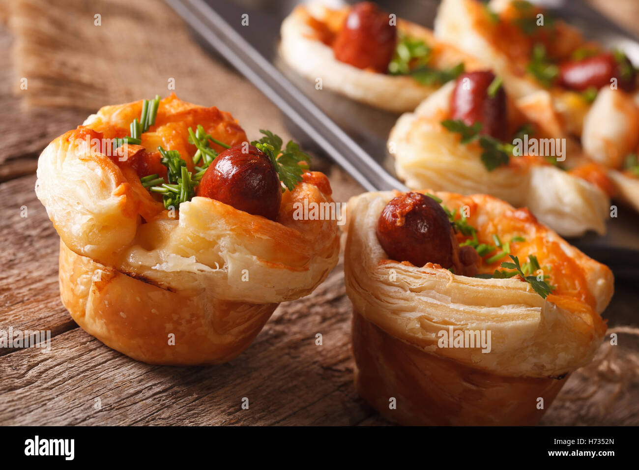 muffins with sausage, cheese and onion macro on the table. horizontal Stock Photo