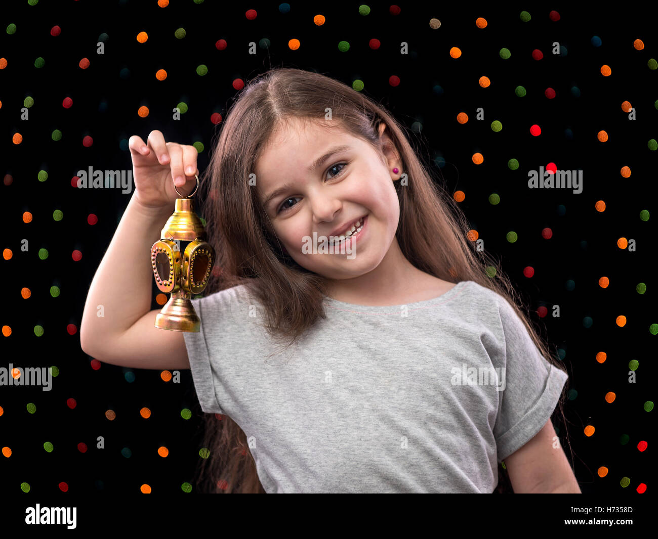 Sweet Little Girl Celebrating with Ramadan Lantern Stock Photo