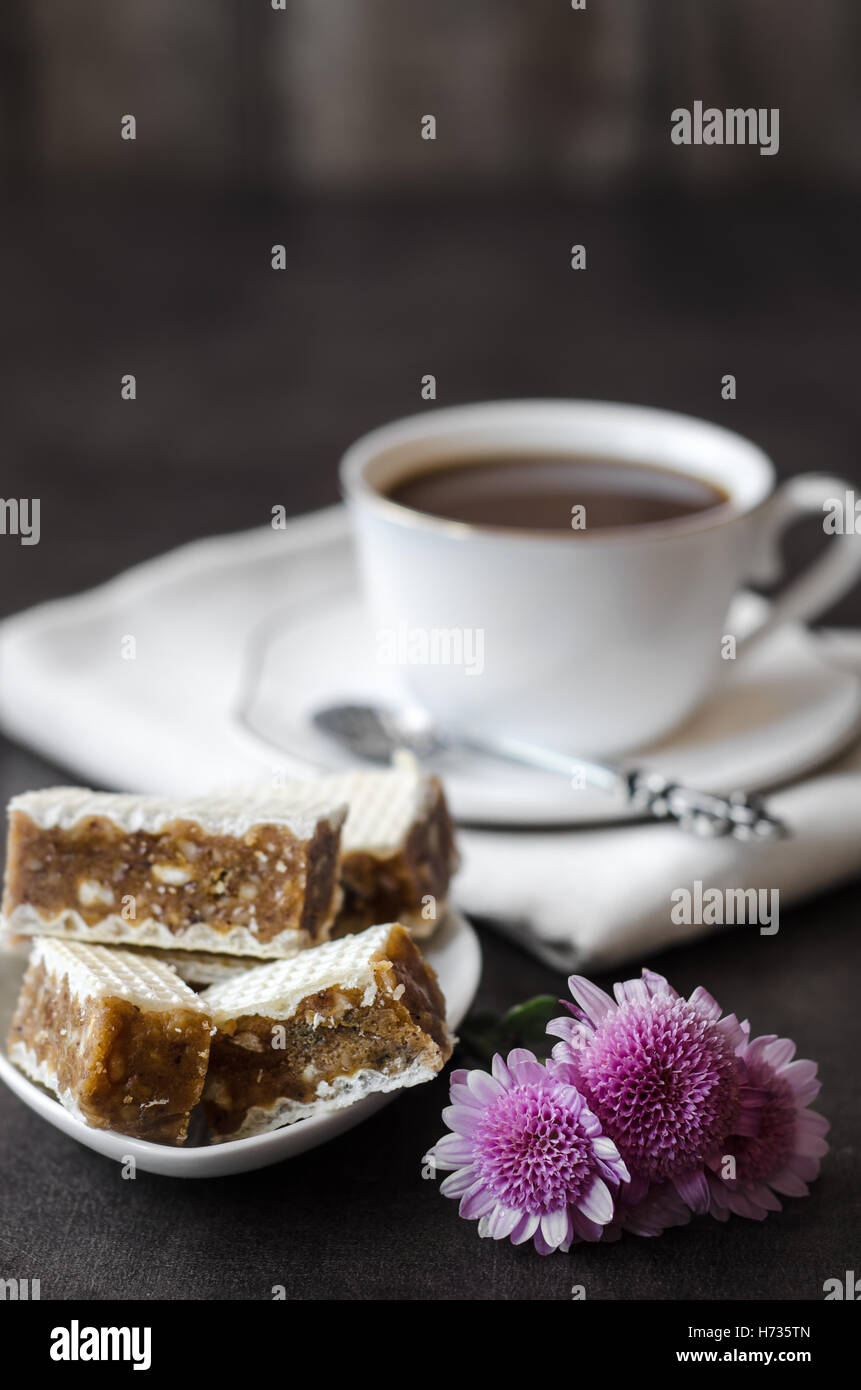 Closeup of wafers puff cakes with caramel and a cup of coffee Stock Photo