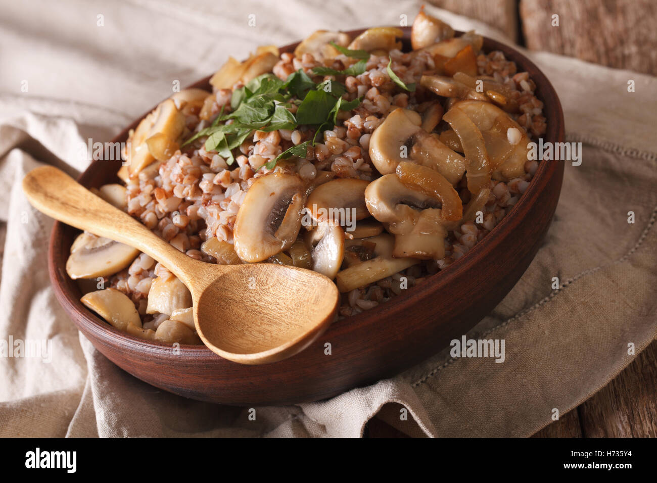 Russian cuisine buckwheat porridge with mushrooms and onions in a bowl