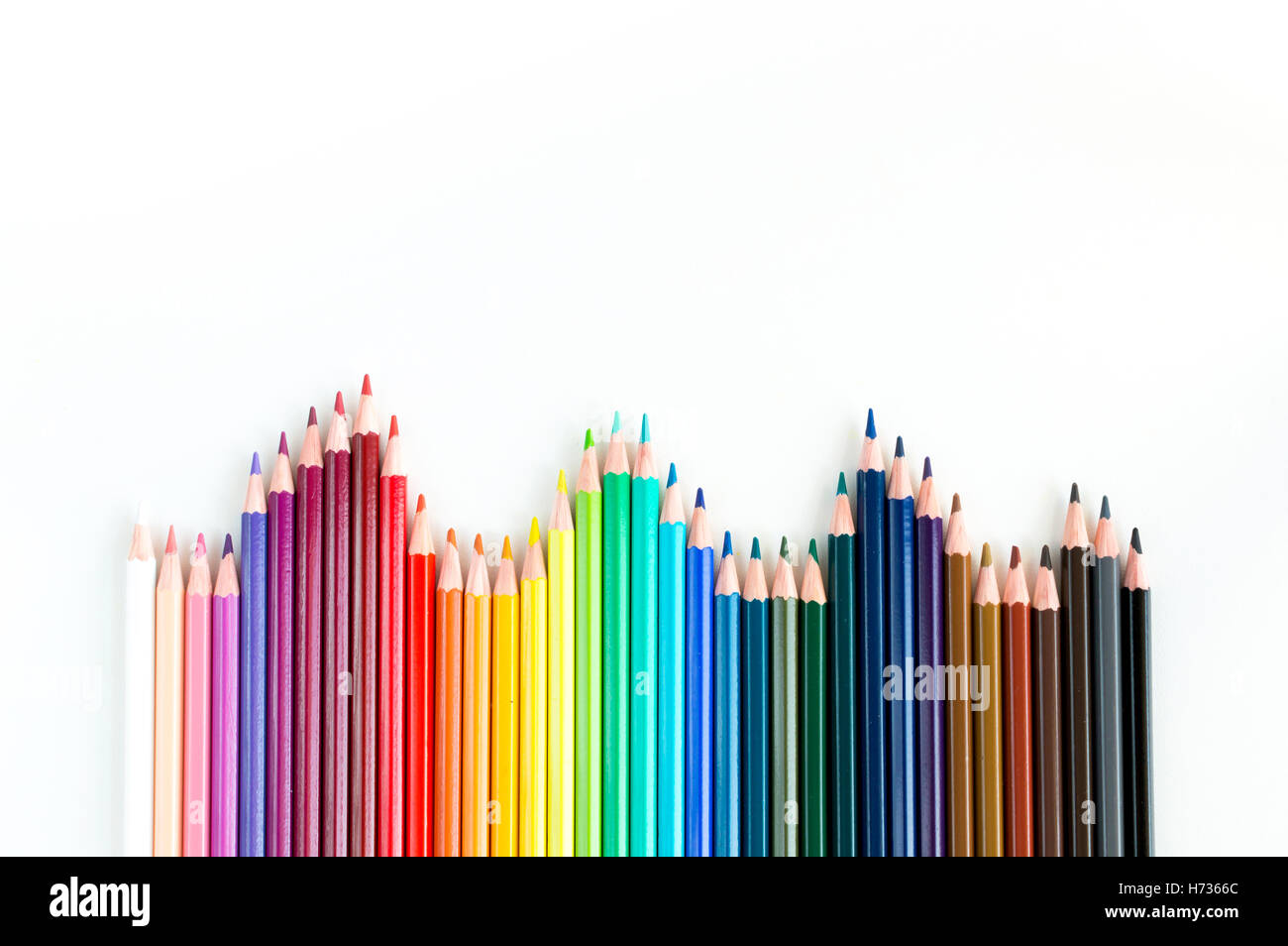 Crayons and watercolor pastels lined up isolated on white background