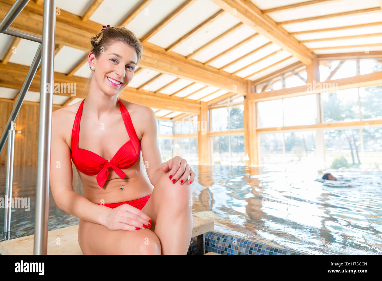 woman sitting by the pool of a wellness spa Stock Photo