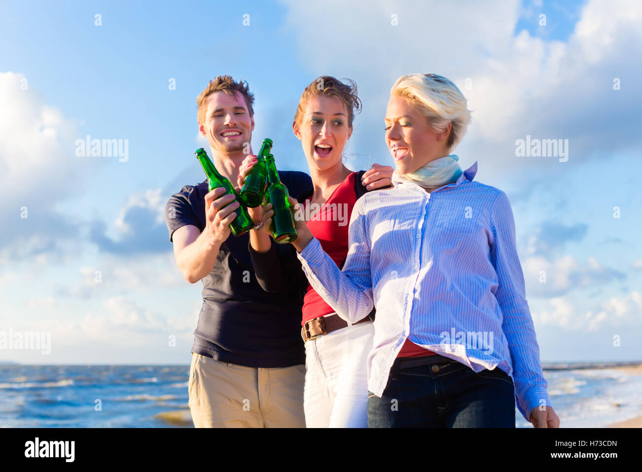 woman women drink drinking bibs relaxation holiday vacation holidays vacations sunset beach seaside the beach seashore water Stock Photo