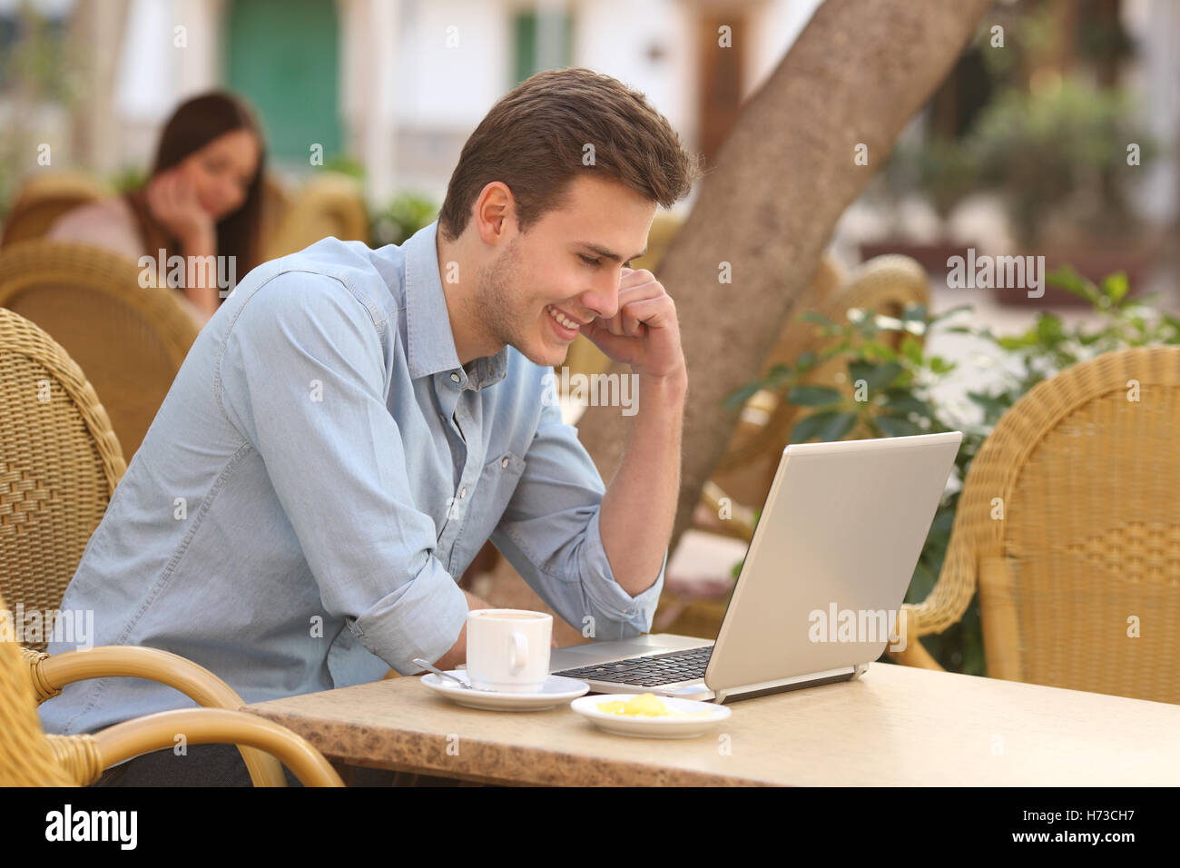 Man watching media in a laptop in a restaurant Stock Photo