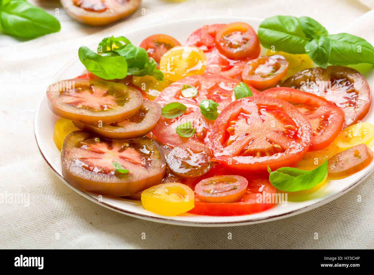 colorful tomato salad with basil Stock Photo