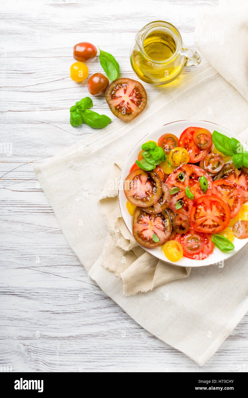 colorful tomatoes salad with basil Stock Photo - Alamy