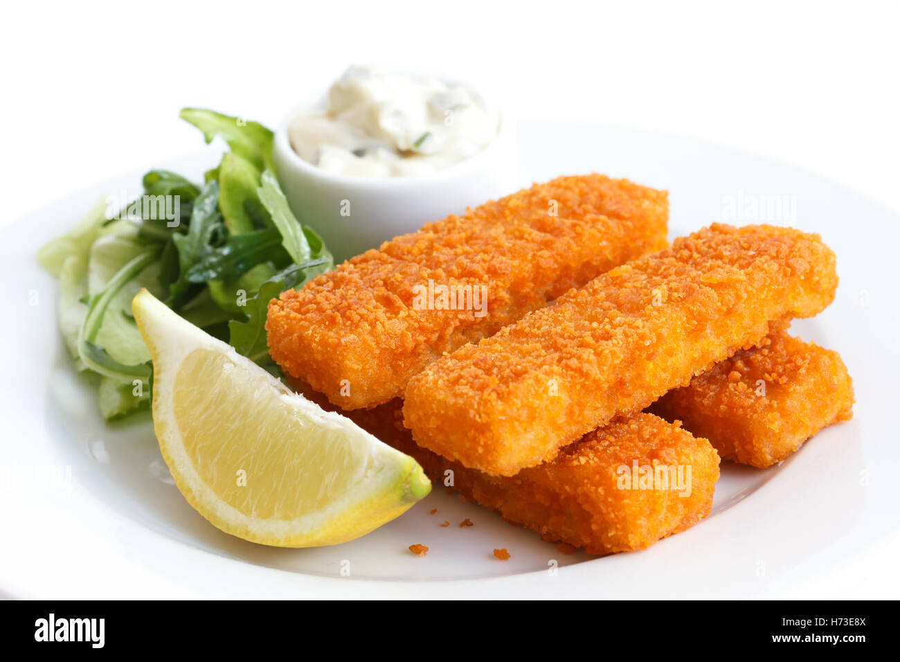Golden fried fish fingers with lemon and tartar sauce Stock Photo