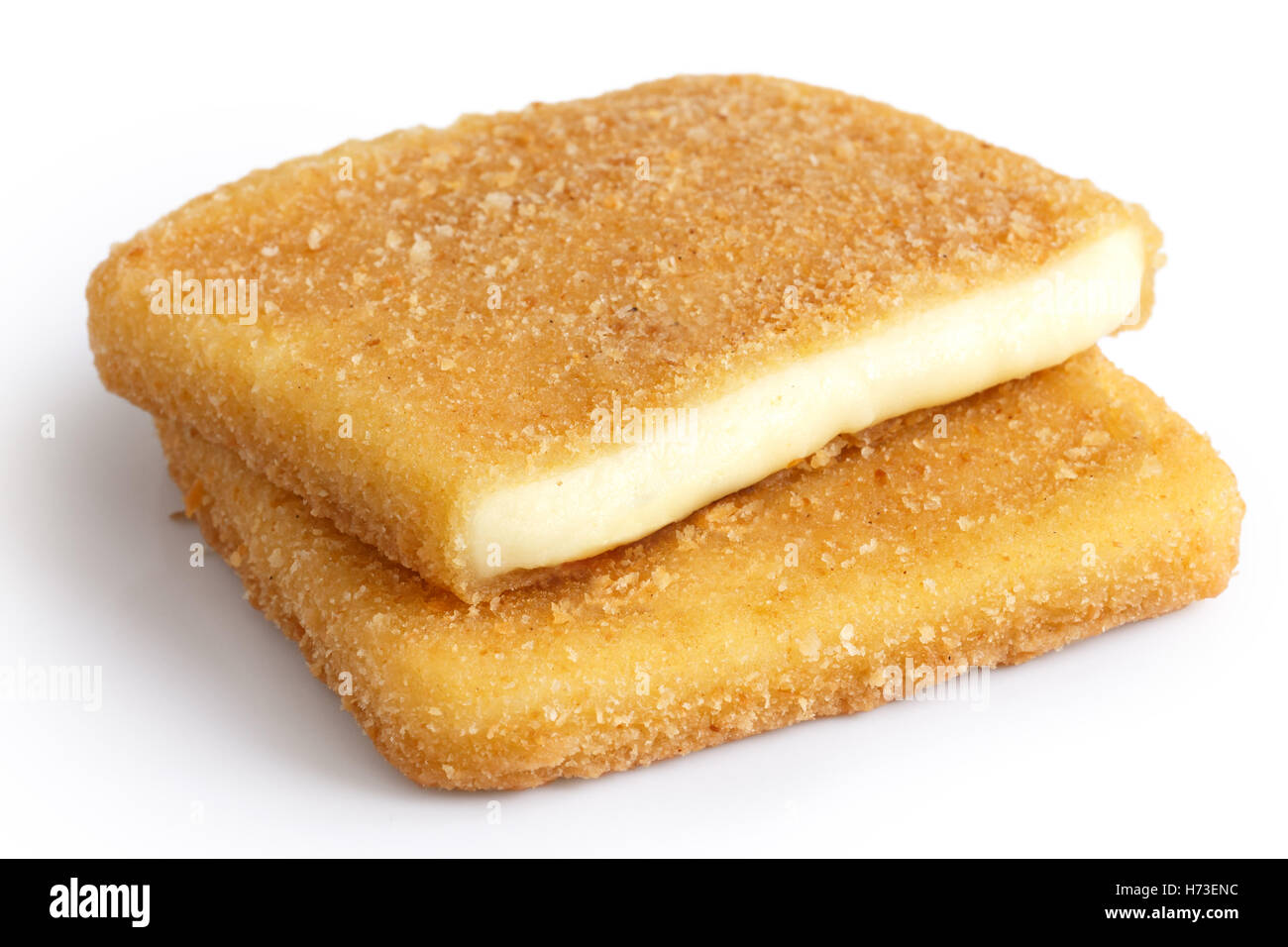 Square golden fried cheeses isolated, cut and melting. Stock Photo