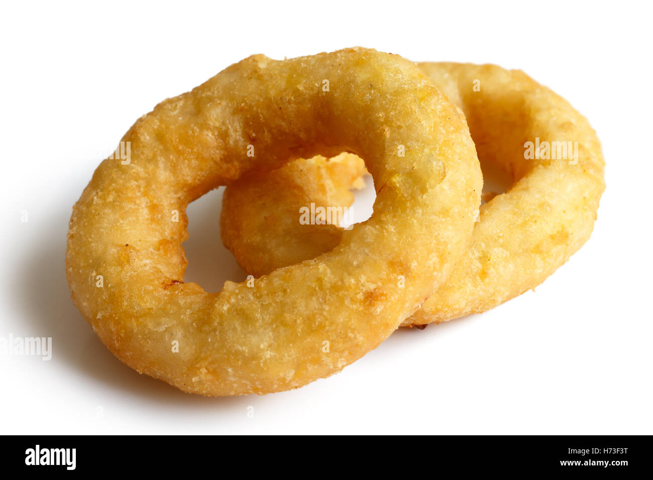 Two deep fried onion or calamari rings isolated on white. Stock Photo