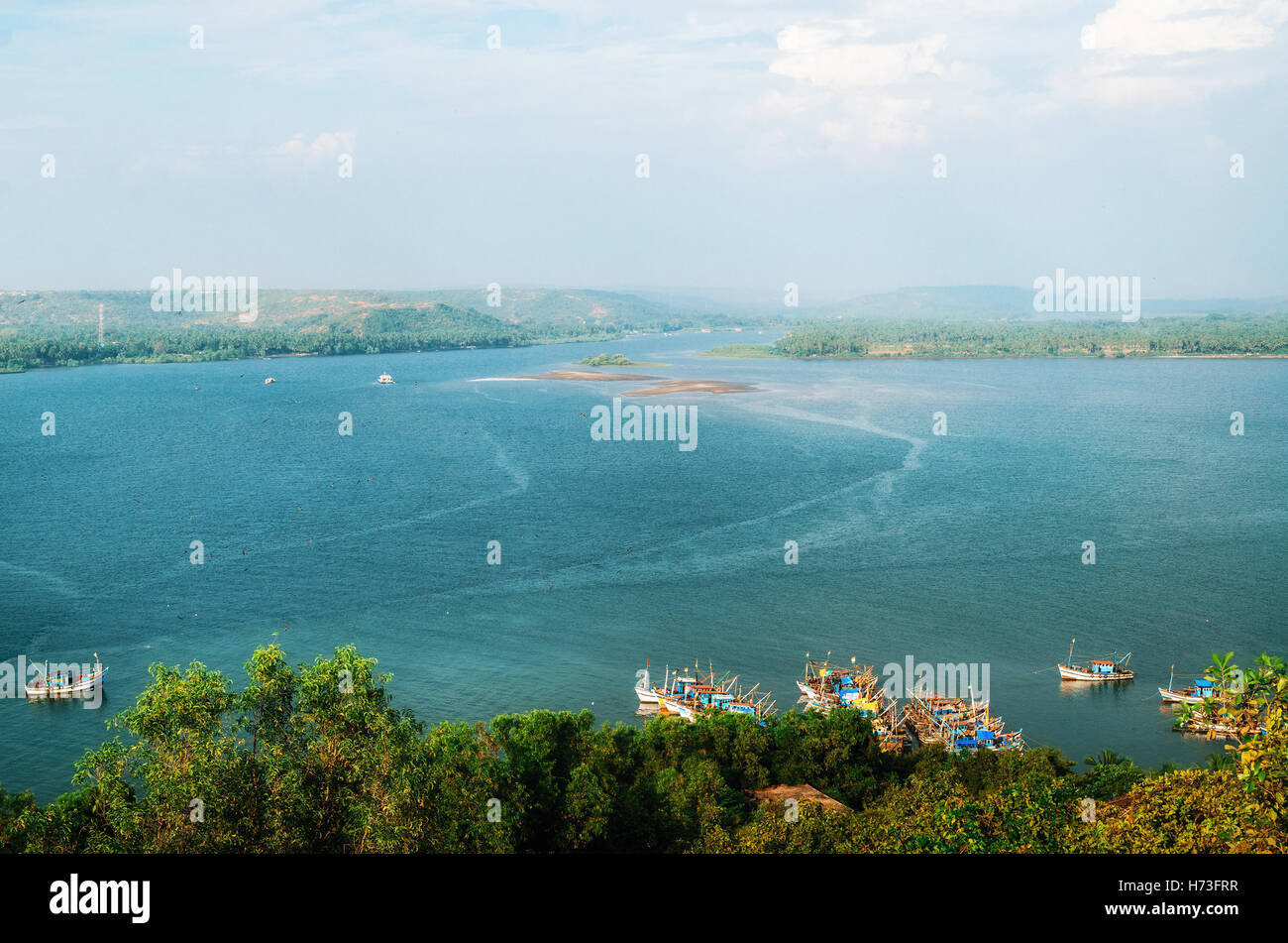 Chapora river with fish market and fishing boats. View of Chapora and Morjim coastline from Chapora Fort, North Goa, India Stock Photo