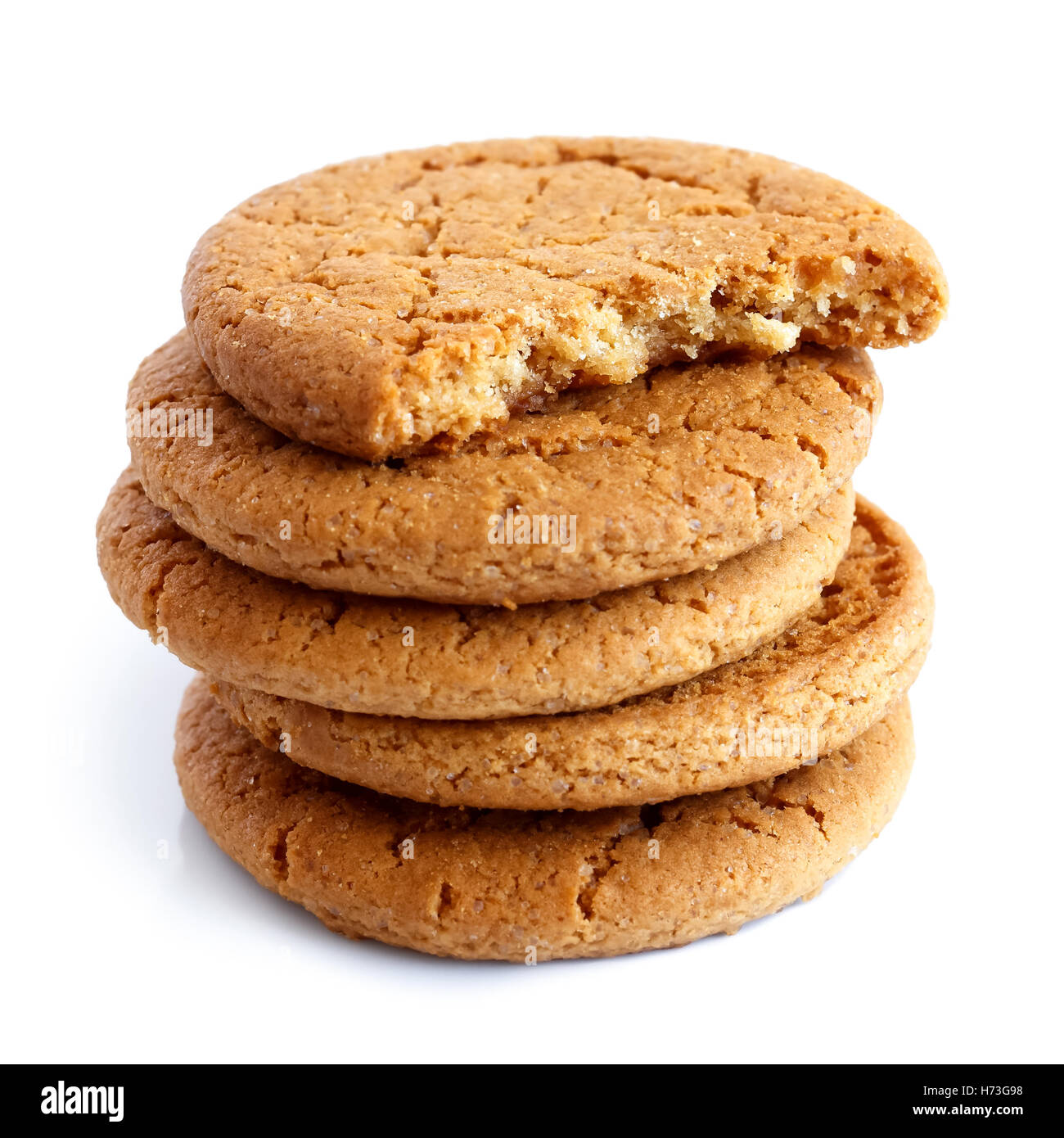 Stack of ginger biscuits with half biscuit on top. Isolated on white