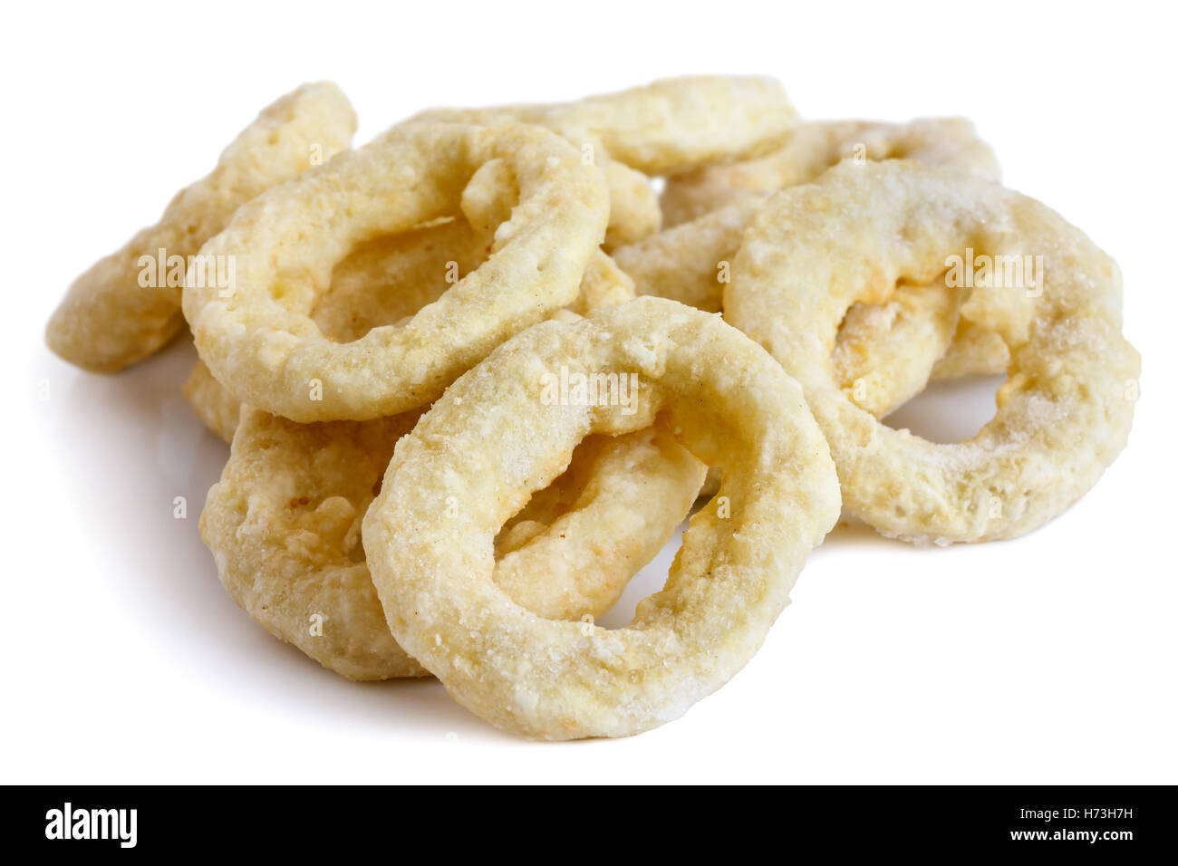 Pile of frozen uncooked battered onion or calamari rings isolated on white. Stock Photo