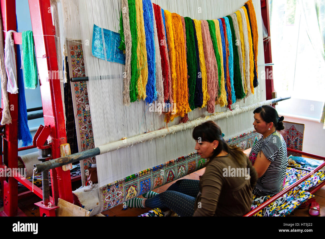 Samarkand Carpet Factory,women working at looms making custom silk,wool carpets,Samarquand