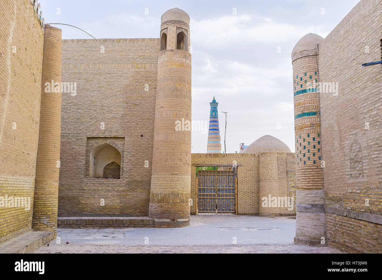 The three different towers of the different mansions and Islam Khoja minaret on the background, Khiva, Uzbekistan. Stock Photo