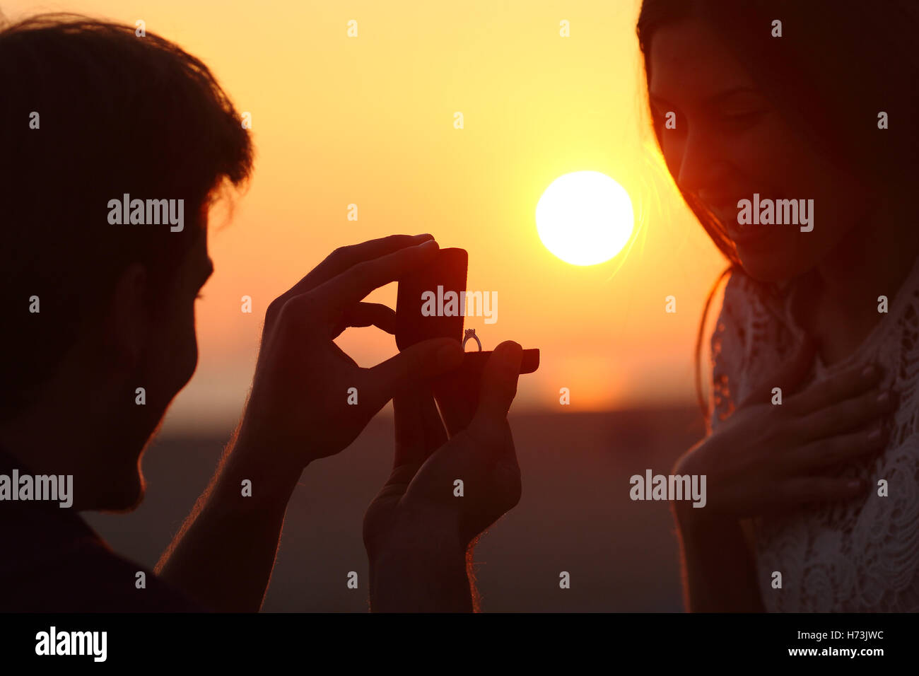 Back light of a proposal of marriage at sunset Stock Photo