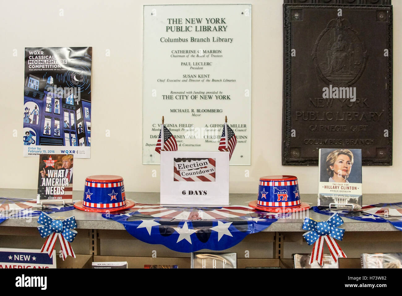 New York, USA. 2nd November, 2016. display at New York Public Library Columbus branch includes plenty of blue bows with white stars & white ribbons with red stripes. Two small American flags support the ends of placard showing countdown days flanked by red white & blue paper hats & a book available at the library about each of the candidates. The ensemble is a subtle reminder to get out the vote Credit:  Dorothy Alexander/Alamy Live News Stock Photo