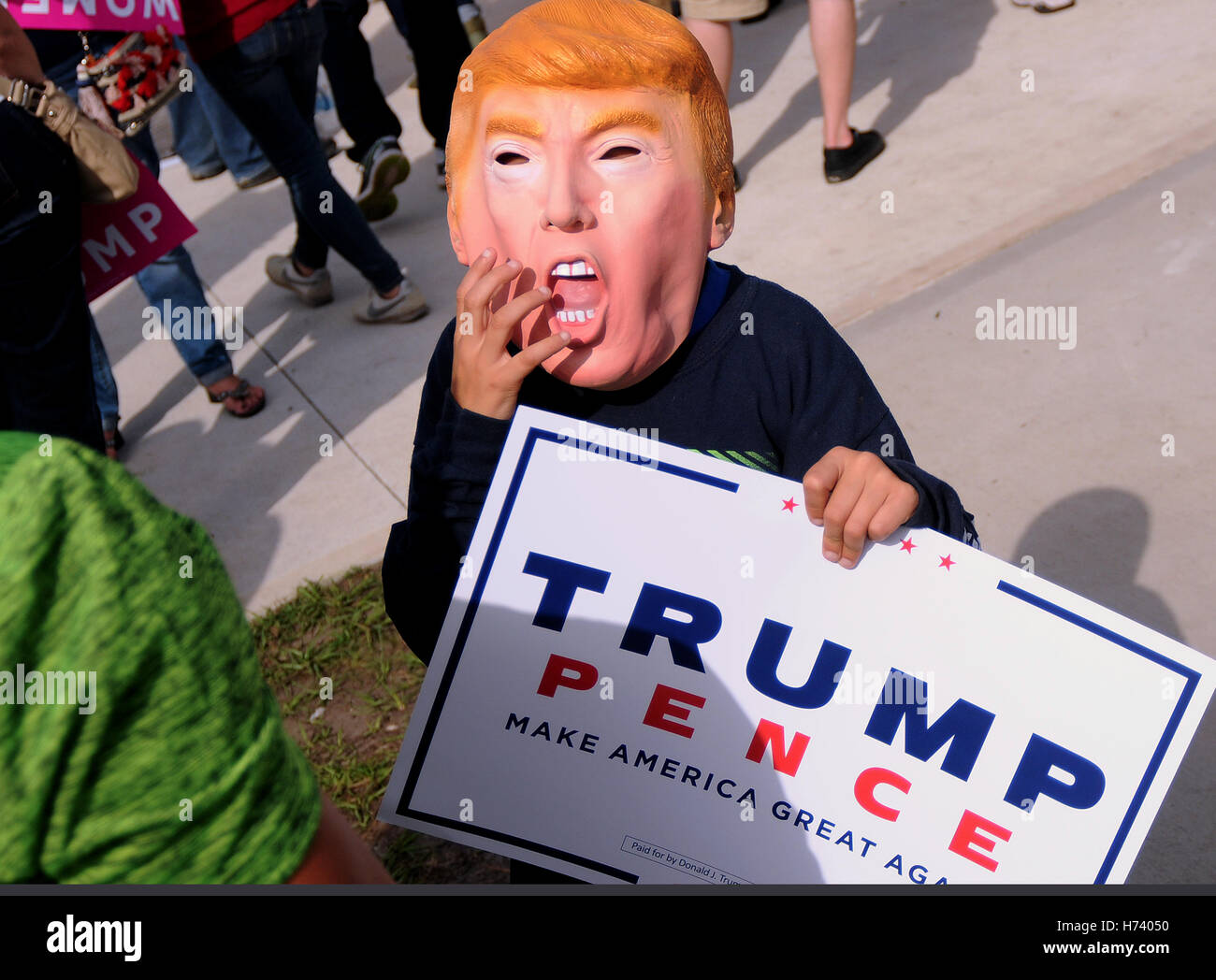 Orlando, Florida, USA. 2nd November, 2016. With the election six days away, a boy wears a Donald Trump mask at a campaign rally for the Republican presidential nominee at the Central Florida Fairgrounds in Orlando, Florida on November 2, 2016. Credit:  Paul Hennessy/Alamy Live News Stock Photo