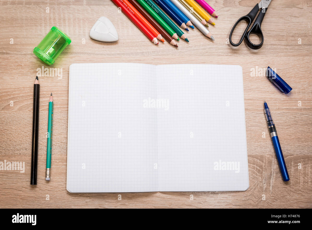Pupils Notebook Pupil's desk with notebook, pencil, crayons, ballpen, scissors ...