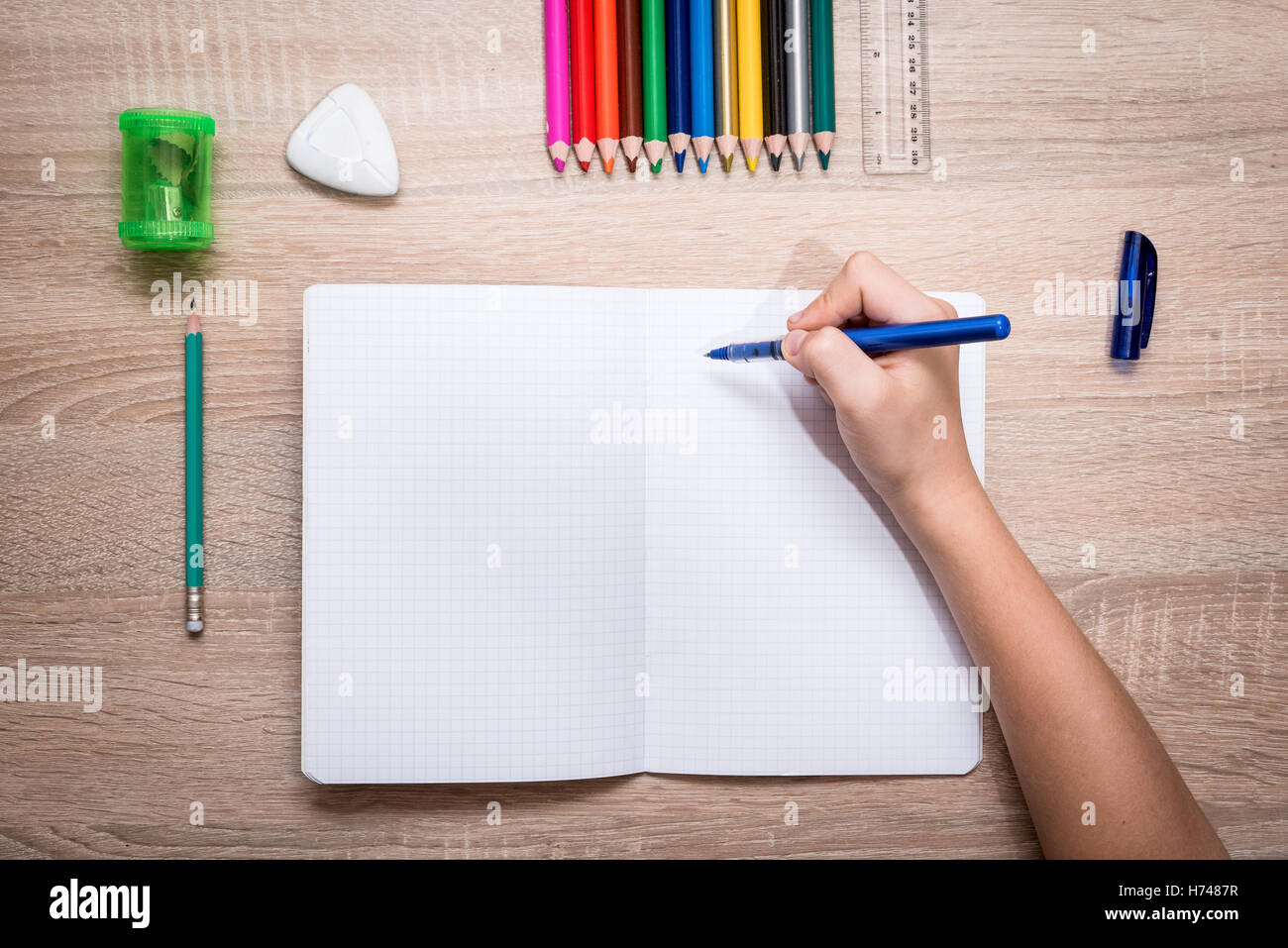 Blank notebook and hand of child ready to do homework. Flat lay Stock ...