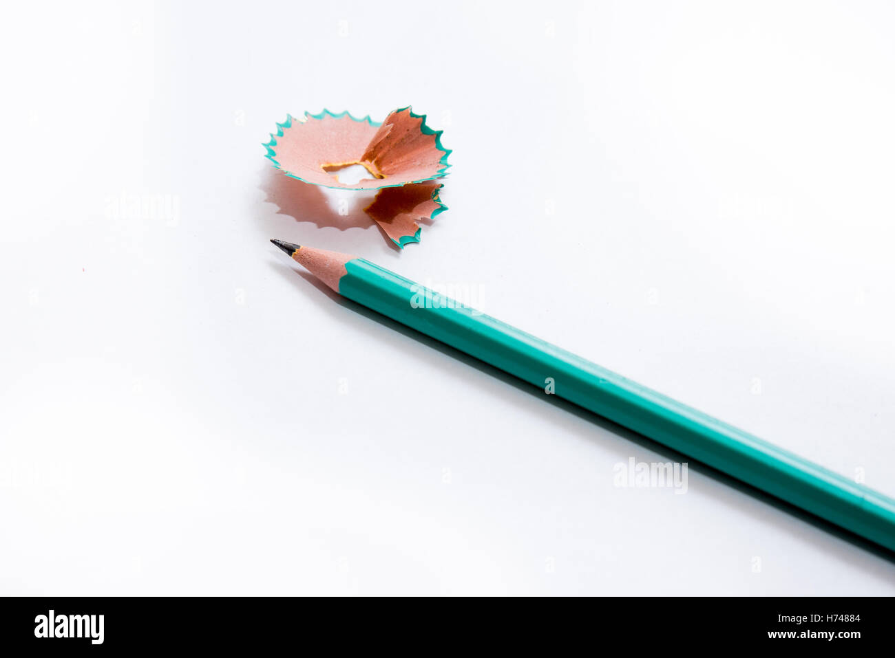 Green pencil and peelings isolated on white Stock Photo