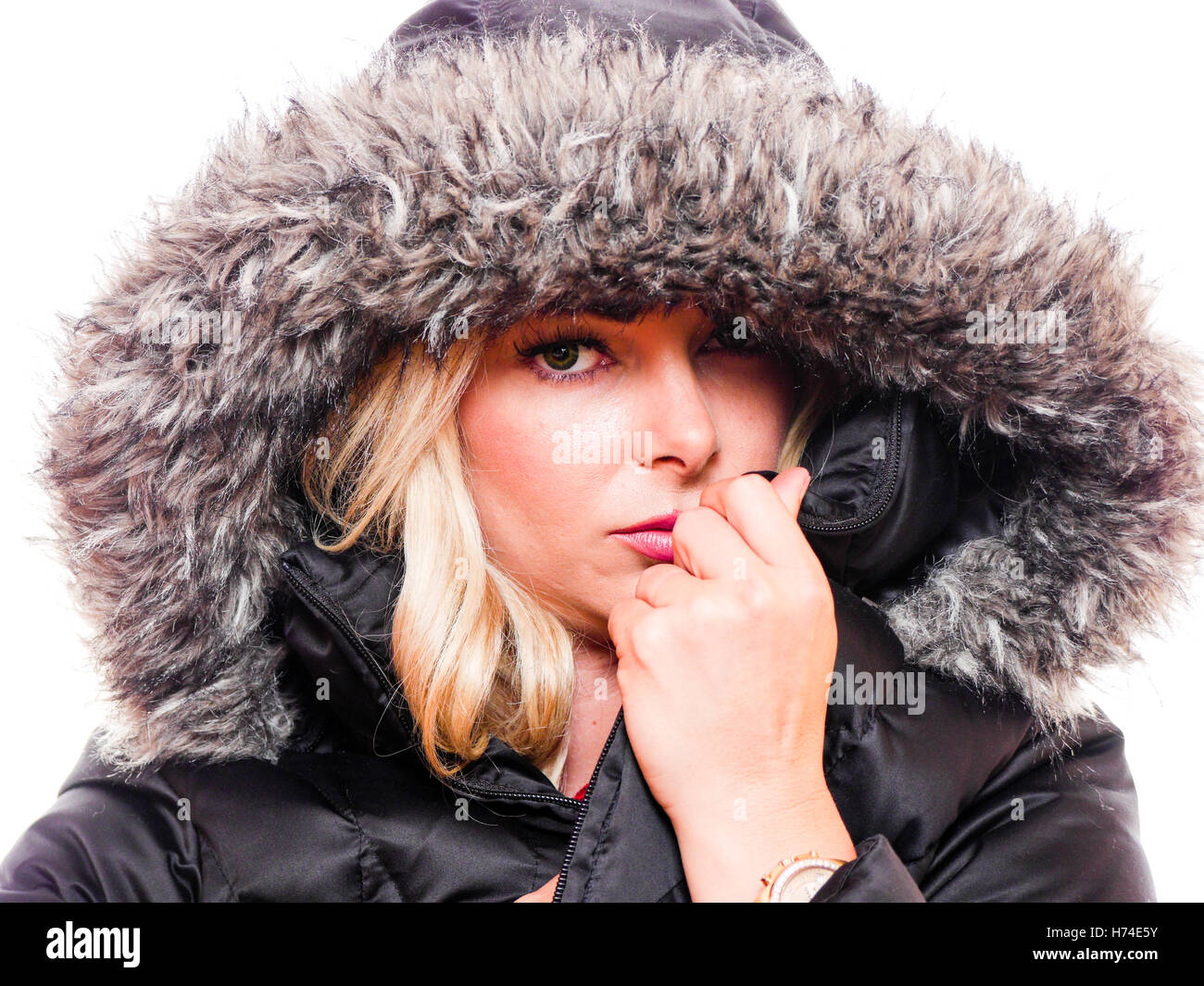 A attractive blond woman is wearing a hood around her head. Stock Photo