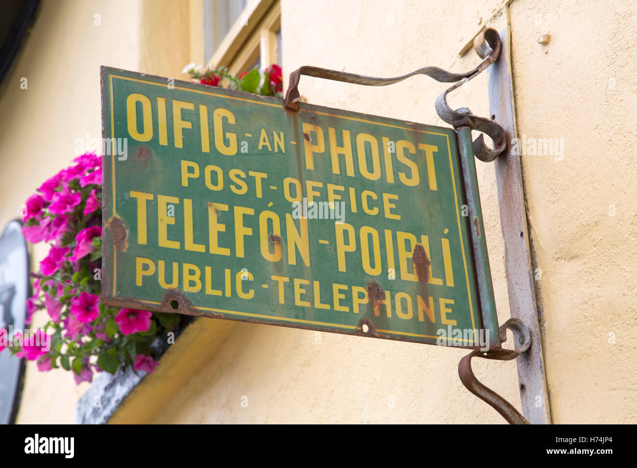 Telephone and Post Office Sign, Westport, Ireland in Irish Gaelic and English Languages Stock Photo