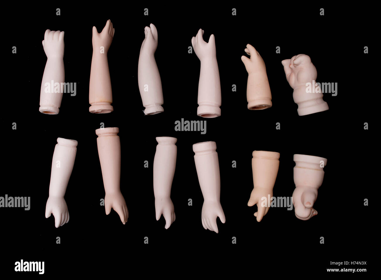 Broken Doll Body Parts Hands and Arms on Black Background Stock Photo -  Alamy