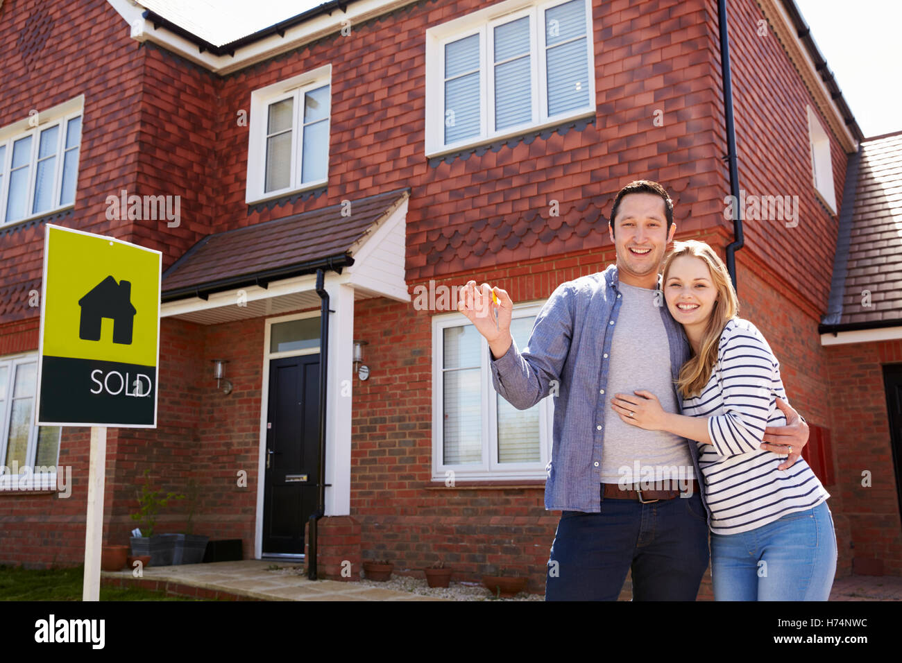 Portrait Of Young Couple With Keys To New Home Stock Photo - Alamy