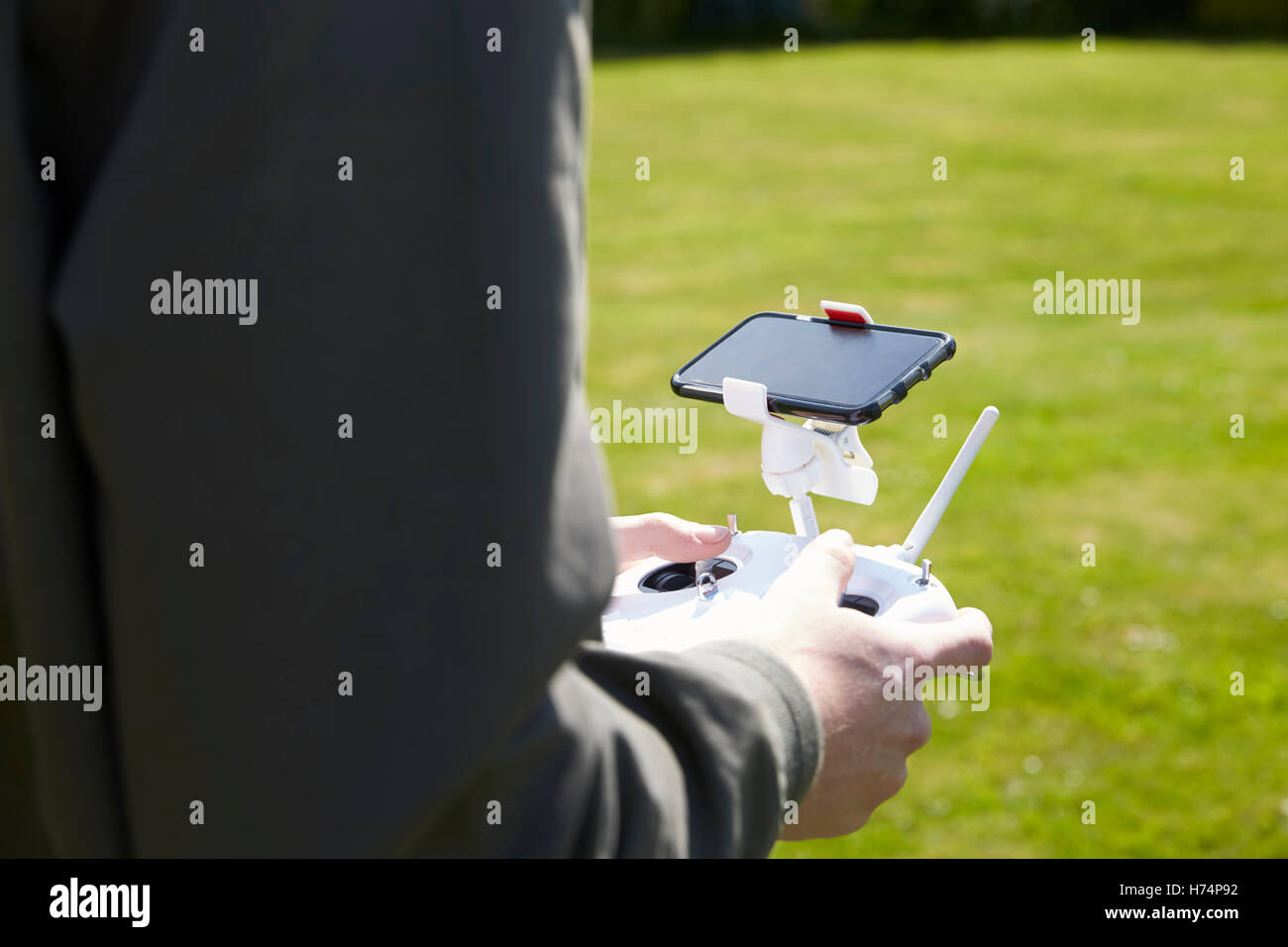 Close Up Of Man Flying Drone Quadcopter In Garden Stock Photo