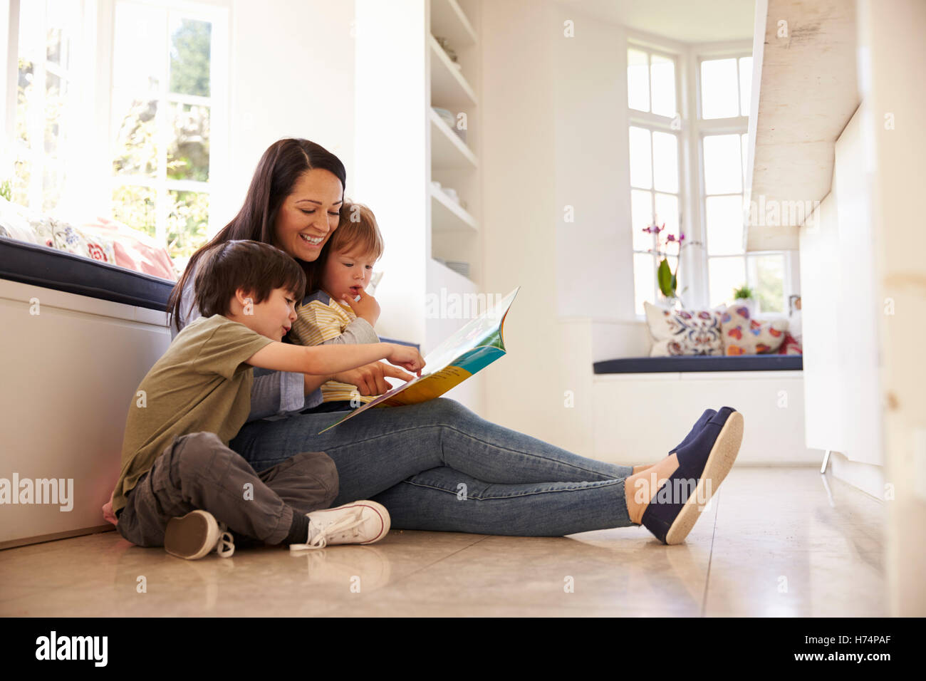 Mother And Sons Reading Story At Home Together Stock Photo Alamy