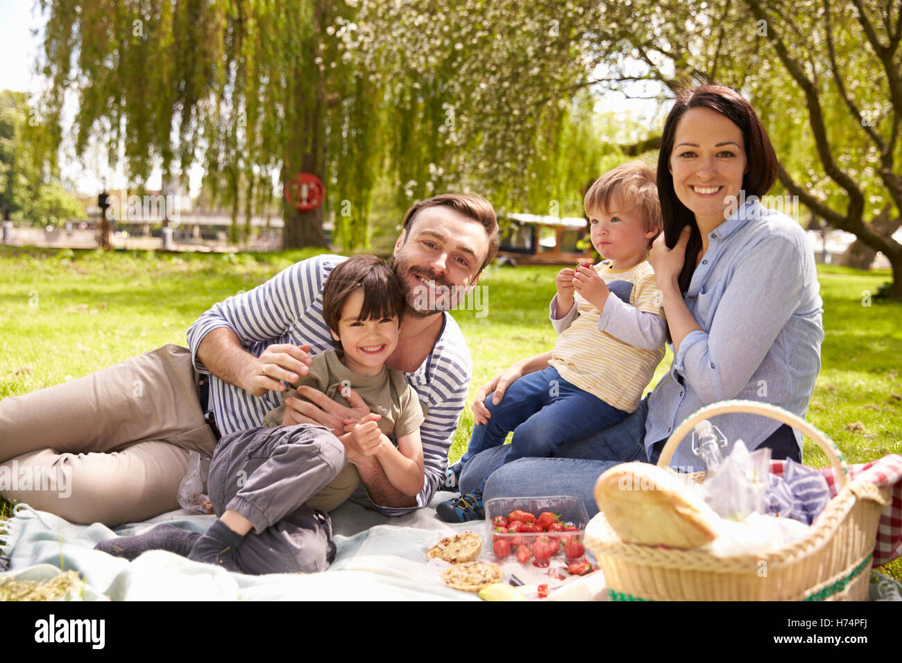 Family Enjoying Riverside Picnic Together Stock Photo Alamy