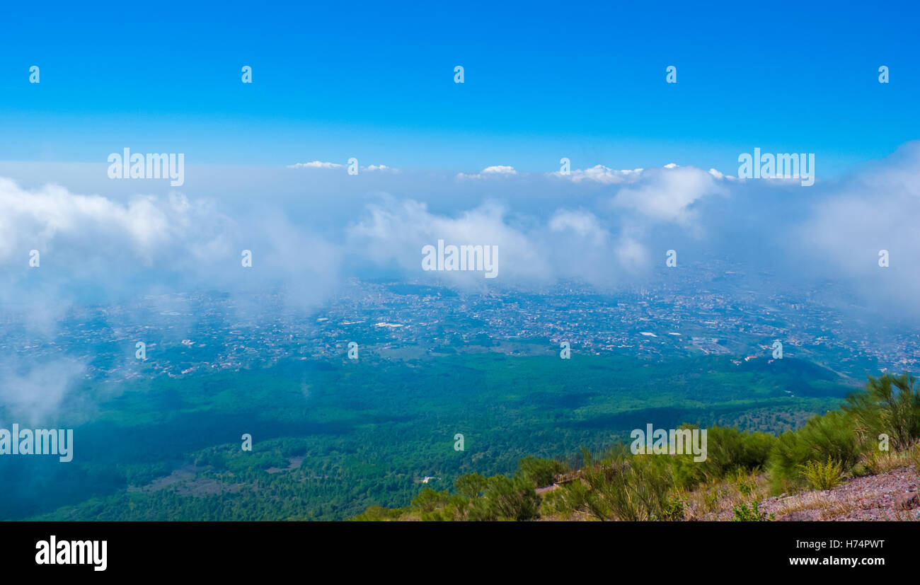 interesting view over the clouds from the top of the Mount Vesuvius on the National park and Pompeii city located under the moun Stock Photo